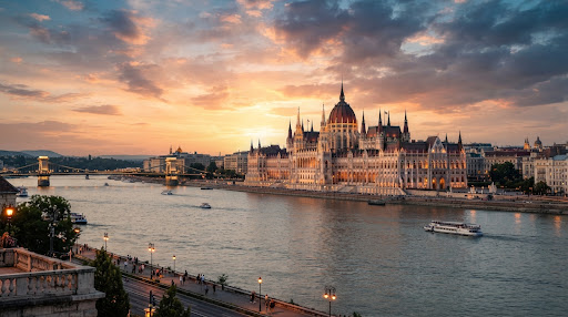 Panorama of the Hungarian Parliament along the Danube in Budapest at sunset.